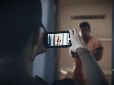 A prison guard takes a picture of a prisoner with a Guardian RFID hand-held Spartan 3