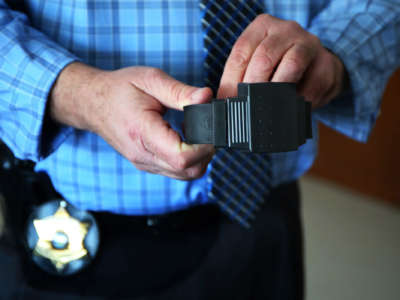 Gregory Shields, director of the Cook County sheriff's electronic monitoring program, shows an electronic ankle bracelet on February 5, 2015.