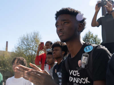 Students clap as Sen. Raphael Warnock speaks at a campaign event at Atlanta University Center Consortium Campus on Election Day on November 8, 2022, in Atlanta, Georgia.