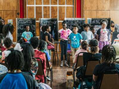 Students present their science fair projects to an audience, exploring topics from pollution to human anatomy at For the Culture in San Antonio, Texas.