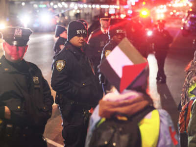 NYPD officers stand guard as people gather to protest the banning of Students for Justice in Palestine (SJP) and Jewish Voice for Peace (JVP) at Columbia University on November 20, 2023, in New York City.