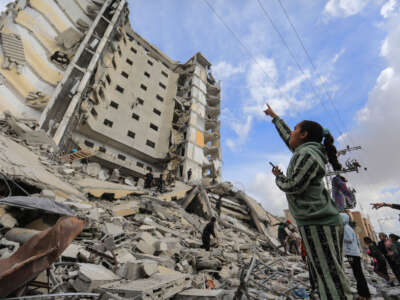Palestinians inspect the massive damage caused by an Israeli air strike on Al-Masry Tower, in downtown Rafah, on March 9, 2024.