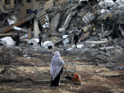 Palestinians collect remaining belongings from the rubble of destroyed houses after Israeli attack Gaza City, Gaza, on March 25, 2024.