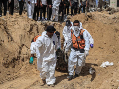 Civil Defence Authority teams work to recover bodies of Palestinians from under the rubble in Khan Yunis, Gaza, on April 21, 2024. The Palestinian Civil Defense Administration in the Gaza Strip said late Saturday that the bodies of 50 Palestinians killed by the Israeli army were recovered from a mass grave in the southern Khan Younis province.