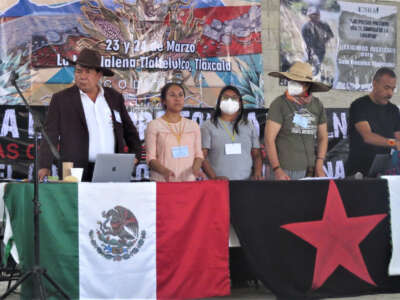 Tlaxcala activists speak out against real estate and other corporate and institutional attacks on their land. In the background, right, is a banner demanding Nahuatl community leader and land defender, Saúl Rosales, be freed.