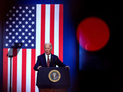 Joe Biden speaks at a podium in front of a U.S. flag