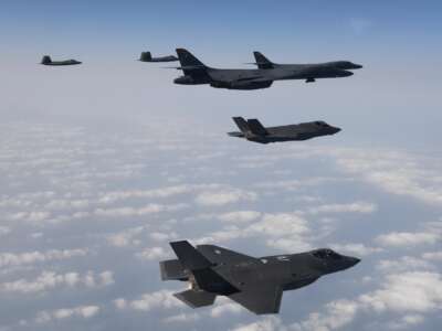 In this handout image released by the South Korean Defense Ministry, U.S. Air Force B-1B bombers (right), F-22 fighter jets and South Korean Air Force F-35 fighter jets (bottom) fly over South Korea Peninsula during a joint air drill on February 1, 2023 at an undisclosed location in South Korea.