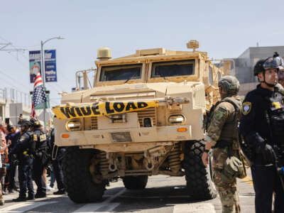 An armored vehicle drives passed a police line outside of the Metropolitan Detention Center on June 10, 2025, in Los Angeles, California.