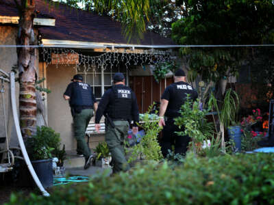 An ICE Enforcement and Removal Operations unit initiates a raid to apprehend immigrants without any legal status and who may be deportable in Riverside, California, on August 12, 2015.