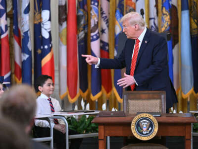 President Donald Trump gestures toward school children during an Education event in the East Room of the White house in Washington, D.C., on March 20, 2025.