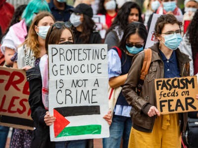 Demonstrators gather on Cambridge Common to protest Harvard's stance on the war in Gaza and show support for the Palestinian people, outside Harvard University in Cambridge, Massachusetts, on April 25, 2025.