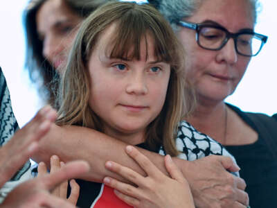 Greta Thunberg is embraced during a press conference for the Freedom Flotilla