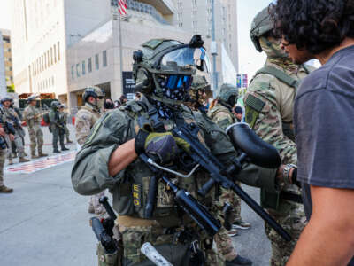 A human being confronts a uniformed and armed agent of the United States