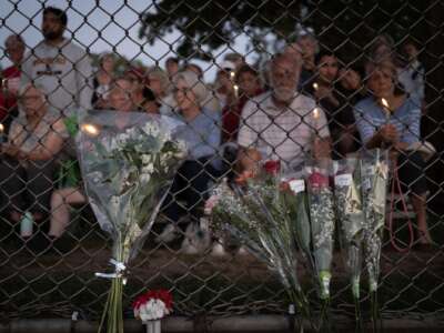 People attend a vigil at Lynnhurst Park to mourn the dead and pray for the wounded after a gunman opened fire on students at Annunciation Catholic School on August 27, 2025 in Minneapolis, Minnesota.