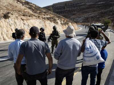 The Israeli army prevents Palestinians from reaching their lands to harvest olives after declaring the area a closed military zone on October 23, 2025, in Si'ir, Hebron.