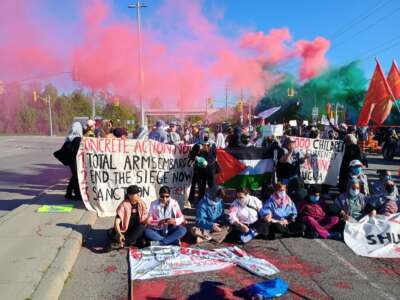 Activists set up roadblocks to shut down all road access to the convention center on CANSEC's opening morning.
