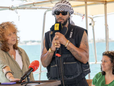 Chris Smalls (center), co-founder and the former president of the Amazon Labor Union, addresses a press conference on the Handala, a Freedom Flotilla ship, ahead of the boat's departure for Gaza at a port in Syracuse, Sicily, southern Italy, on July 13, 2025.