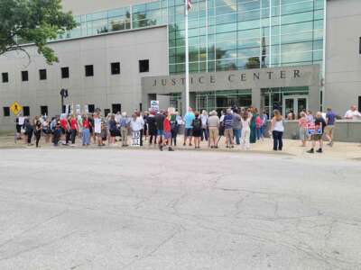 Protesters hold a rally outside the CoreCivic prison in Leavenworth, Kansas, on August 6, 2025. Meanwhile, a judge considers whether the company needs a special use permit to open.