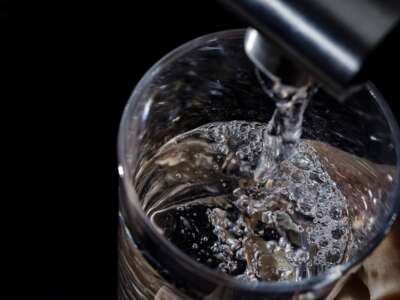 Water flows from a tap into a glass