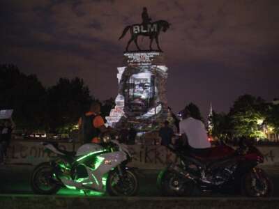 An image of Frederick Douglass is projected onto the Robert E. Lee Statue on Monument Avenue in Richmond, Virginia, on June 18, 2020.