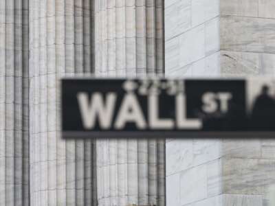 A Wall Street sign hangs at the New York Stock Exchange on Wall Street on March 23, 2021, in New York City.