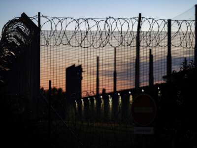 Barbed wires on a fence of the Toulouse-Seysses detention center at sunrise in Seysses, southwestern France, September 7, 2022.