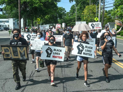Protestors march against racism and police brutality on Broadway in Amityville, New York, on July 5, 2020.