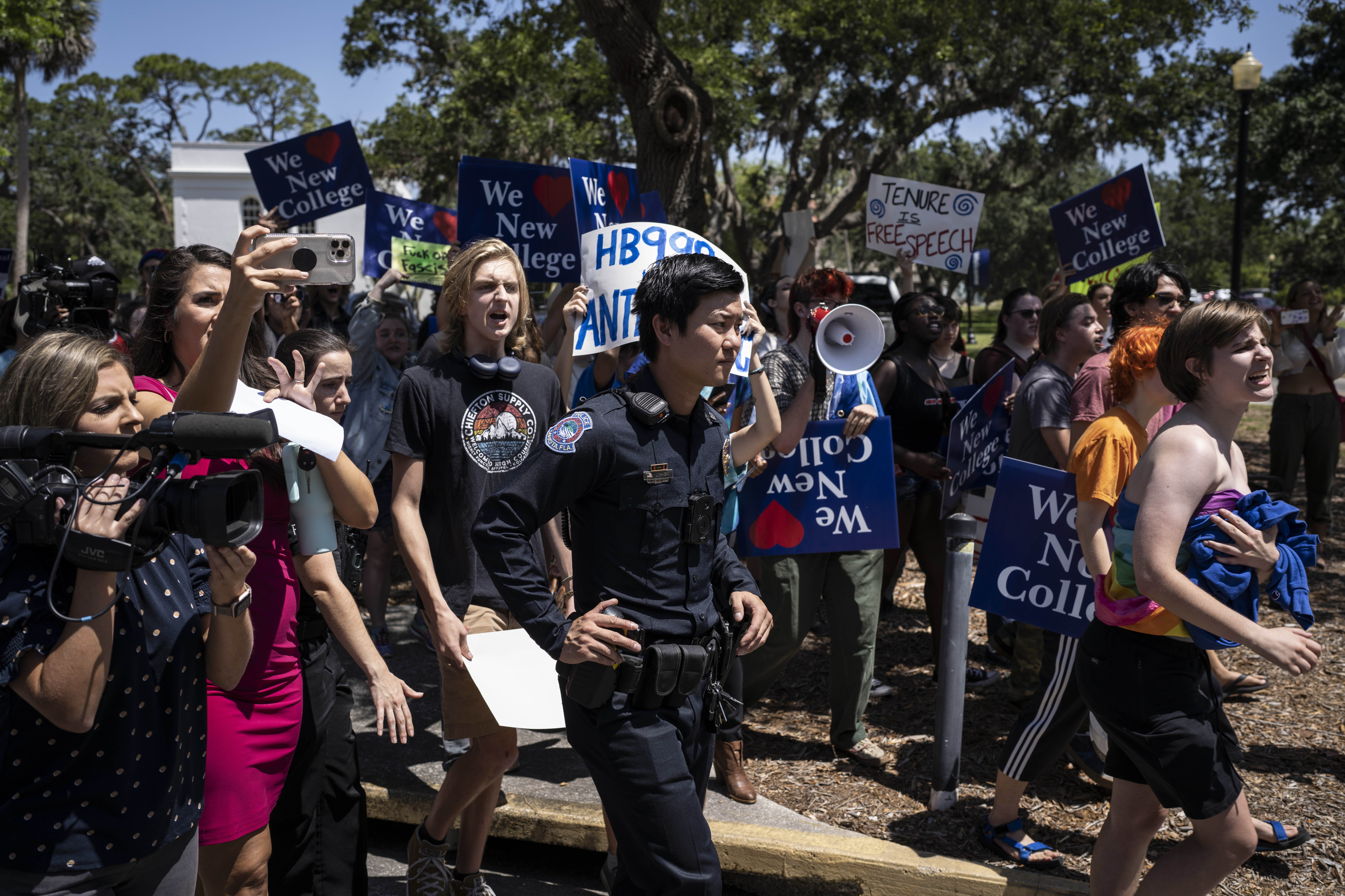 Protestors on the campus of New College of Florida chase after Christopher Rufo, a conservative activist and New College of Florida trustee, after he attended a bill signing event featuring Florida Governor Ron DeSantis, who signed three education bills in Sarasota, Florida, on Monday, May 15, 2023.