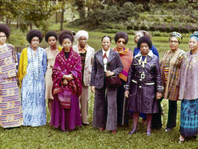 From left to right: Malaika Wangara, Linda Brown Bragg, Carole Gregory Clemmon, Alice Walker, Mari Evans, Gloria Oden, June Jordan, Marion Alexander, Margaret Danner, Audre Lorde and Margaret Goss Burrough, participants of The Phillis Wheatley Poetry Festival standing in a garden.
