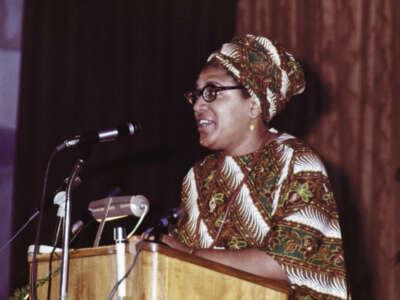 Audre Lorde talking on microphone at The Phillis Wheatley Poetry Festival.