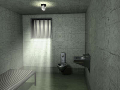 An empty jail cell in a traditional prison.