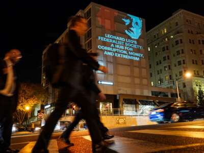 A projection is seen on a building condemning right-wing legal activist Leonard Leo and the Federalist Society as government watchdog Accountable.US launches a campaign during the Federalist Society annual conference on November 9, 2023, in Washington, D.C.