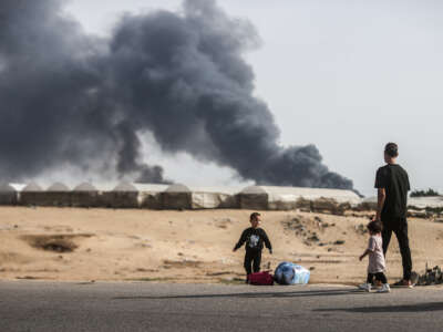 Palestinians flee after the Israeli army targets tents in Al-Mawasi, previously declared as a "safe zone" by Israel, in the city of Rafah in southern Gaza, on May 28, 2024.