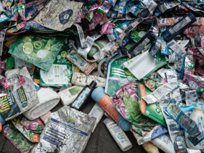 Members of Greenpeace Indonesia display plastic waste from British multinational hygiene and food giant Unilever's products as part of their "Return to Sender" action in front of Unilever's office in Tangerang, a suburb of Jakarta, on June 20, 2024.