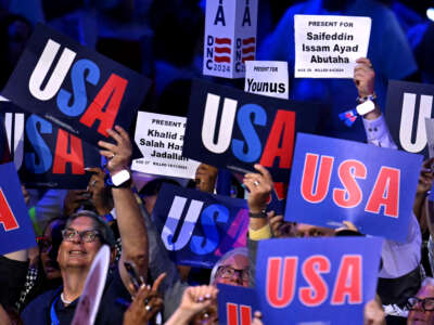 Attendees hold up signs with the names of people who died in the Gaza war on the second day of the Democratic National Convention (DNC) at the United Center in Chicago, Illinois, on August 20, 2024.