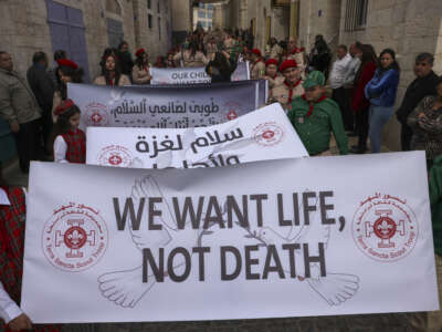 Palestinians partake in the yearly Christmas procession towards the Church of the Nativity in Bethlehem town in the Israel-occupied West Bank on December 24, 2024.