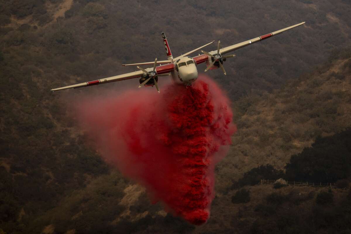 A CAL FIRE S-2T firefighting tanker releases retardant while battling the Palisades Fire in the Mandeville Canyon neighborhood of Los Angeles, California, on January 11, 2025. A new bill prohibits the EPA from restricting any chemicals used in aerospace fire suppression that have been certified by the Federal Aviation Administration or the Department of Defense. Such firefighting foams were previously a major source of per- and polyfluoroalkyl substances (PFAS).