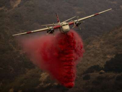 A CAL FIRE S-2T firefighting tanker releases retardant while battling the Palisades Fire in the Mandeville Canyon neighborhood of Los Angeles, California, on January 11, 2025. A new bill prohibits the EPA from restricting any chemicals used in aerospace fire suppression that have been certified by the Federal Aviation Administration or the Department of Defense. Such firefighting foams were previously a major source of per- and polyfluoroalkyl substances (PFAS).