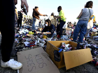 Thousands of people pick up clothes, foods and toiletries during a wildfire relief pop-up for those effected by the Eaton Fire, at Santa Anita Park in Arcadia, California, on January 11, 2025.