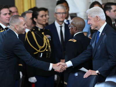 House Minority Leader Hakeem Jeffries shakes hands with former President Bill Clinton following the inauguration of Donald Trump in the U.S. Capitol Rotunda on January 20, 2025, in Washington, D.C.