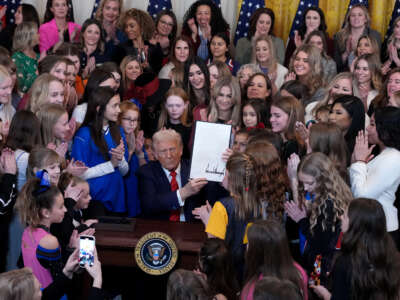 President Donald Trump joined by women athletes signs the “No Men in Women’s Sports” executive order in the East Room at the White House on February 5, 2025, in Washington, D.C.