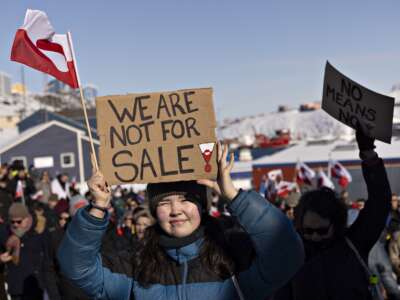 A protester holds a sign reading “We are not for sale” in front of the U.S. consulate during a demonstration in Nuuk, Greenland, on March 15, 2025.