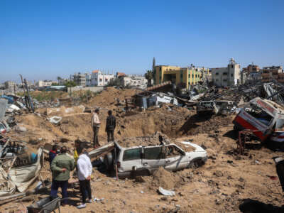 Palestinians inspect the damage at an ambulance repair yard hit in Israeli strikes in the al-Maghazi refugee camp in the central Gaza Strip on March 24, 2025.