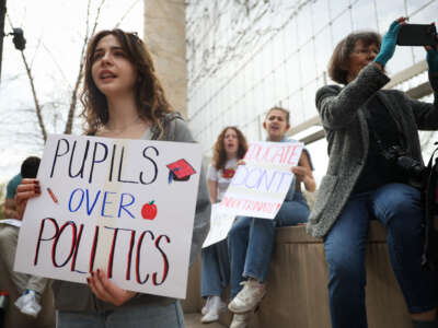 (L-R) George Washington University students Eveline Straub, Kaitlyn Gang, and Sonia Lerner holds a signs next to Julie Byrne during the "Hands Off Our Schools" rally in front of the U.S. Department of Education on April 4, 2025, in Washington, D/C. Students from Georgetown University, Howard University, American University, George Washington University, George Mason University, and Temple University gathered to protest President Donald Trump dismantling of the U.S. Department of Education.