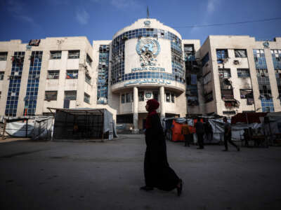 Displaced Palestinians sit by their makeshift tents outside the UNRWA-run clinic at al-Shati refugee camp in Gaza City, Palestine, on April 28, 2025.