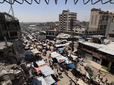 Palestinians gather at a market at the Nuseirat refugee camp in the central Gaza Strip, on May 10, 2025.