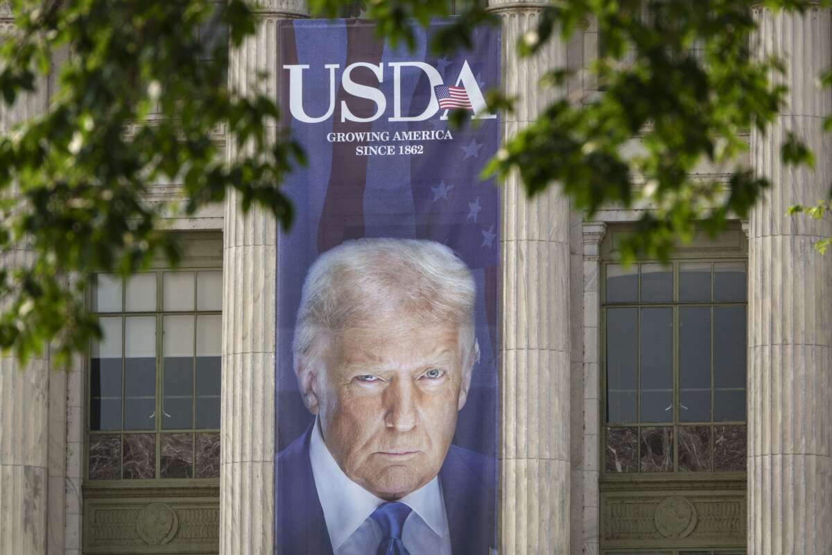 A banner showing a picture of Donald Trump is displayed outside of the U.S. Department of Agriculture building on June 3, 2025, in Washington, D.C.