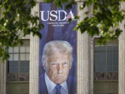 A banner showing a picture of Donald Trump is displayed outside of the U.S. Department of Agriculture building on June 3, 2025, in Washington, D.C.
