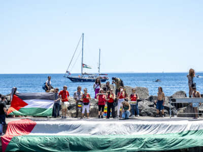 A group of activists greets the departure of the Madleen for Gaza with songs and Palestinian flags on June 1, 2025, in Catania, Italy. Swedish activist Greta Thunberg is among those who will attempt to sail to Gaza on a boat organized by the Freedom Flotilla Coalition in a bid to break Israel's blockade of Palestine.