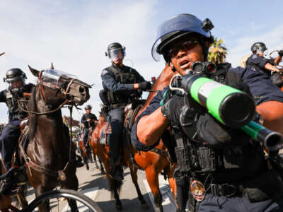 Protesters face off with police outside of a federal building in downtown Los Angeles for an anti-Trump "No Kings Day" demonstration in a city that has been the focus of protests against Trump's immigration raids on June 14, 2025, in Los Angeles, California.